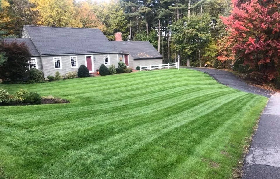 Ty Mello Landscaping crew mowing a lawn